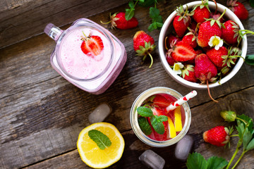 Dietary breakfast for summer time, vegan food concept. Fresh Strawberry milkshake and strawberry lemonade on rustic wooden table. Top view flat lay background. Copy spase.