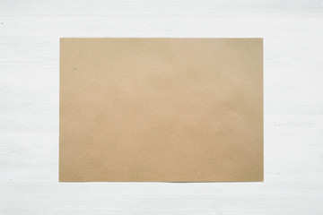 Blank paper page on a white wooden board background. Agreement mockup.