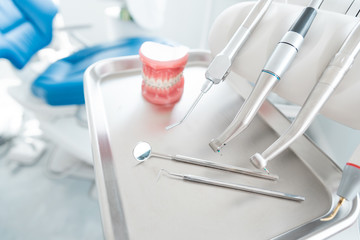 Fototapeta na wymiar Dental drills and jaw model in dentists office