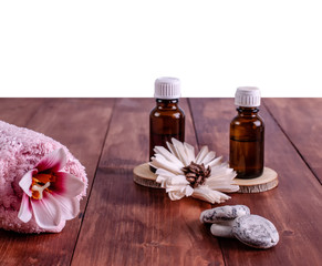 Fototapeta na wymiar Aromatherapy oils, small stones, pink towel