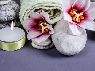 Spa set with stones, candle, orchid flowers