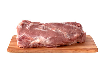 A piece of meat on a white background. Raw piece of pork on a wooden board.