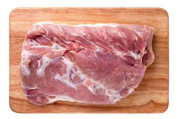 A piece of meat on a white background. Raw piece of pork on a wooden board.