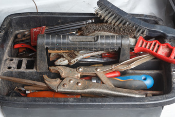 Fototapeta premium Plastic toolbox with pliers, screwdriver, brush, drills and wrench