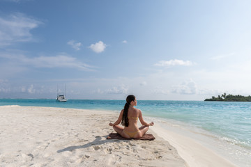 Fototapeta na wymiar Meditation - Yoga woman meditating at serene beach.