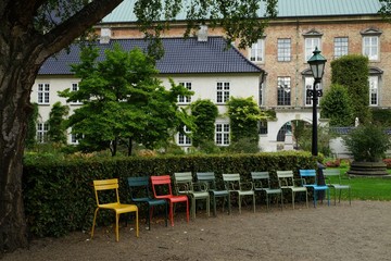 Fototapeta na wymiar Multicolored garden chairs at Det kongelige Biblioteks Have