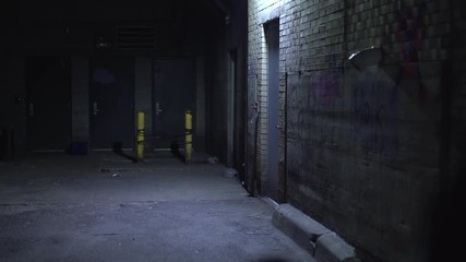 Back door of business in dark alley at night 4k