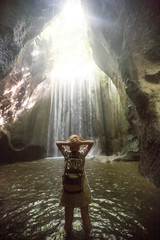 Woman near waterfal on Bali, Indonesia 