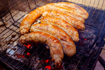 Grilled sausage on the picnic flaming grill outdoor
