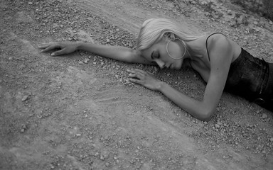 Attractive young woman on the sand. Fashion black and white portrait