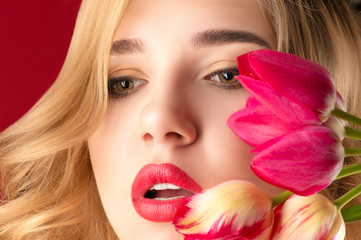 beautiful portrait surprised woman with bright makeup and flowers close up