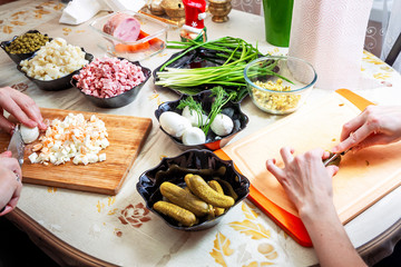 preparing russian salad 'Olivier'