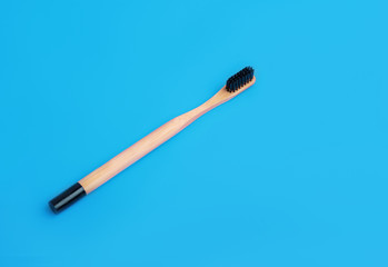 Flat lay composition with bamboo toothbrush space for text on color background