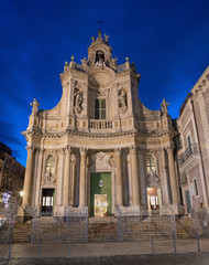 Fototapeta na wymiar Catania - The baroque facade of church Basilica Collegiata at dusk.