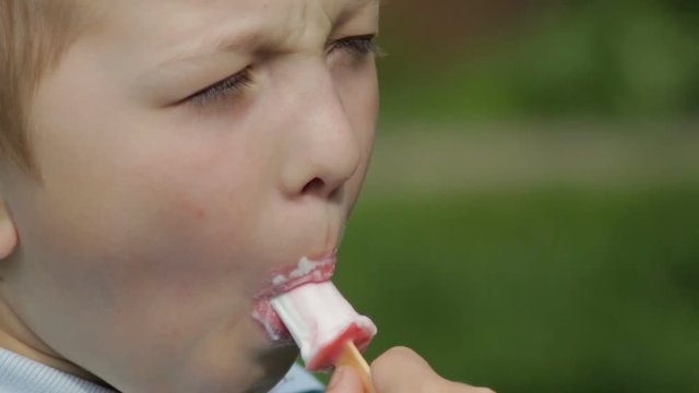 child licks ice cream,Close-up boy licking ice cream in a delicious summer
