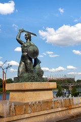 Mermaid statue in Warsaw in Powiśle, in the background the Vistula and the National Stadium © Monika