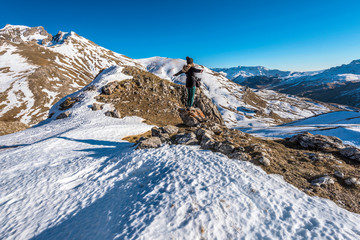 Girl hiker is staying in the stone facing to the panoramic view of upper Tena Valley in Spanish...