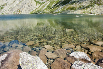 Fototapeta na wymiar View of beautiful lake in the summer mountains