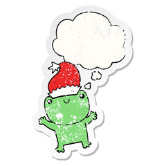 cute cartoon frog wearing christmas hat and thought bubble as a distressed worn sticker