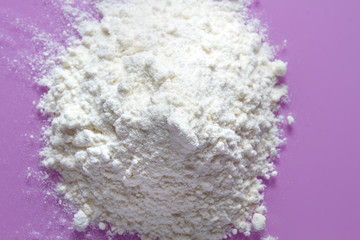 White wheat flour on a purple background