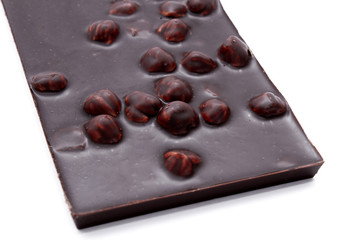Black chocolate bar with nuts isolated on white background