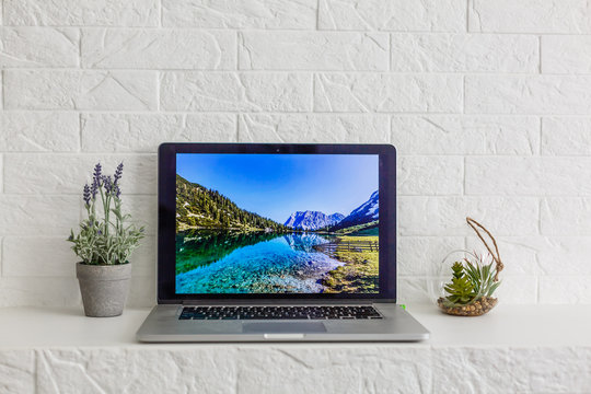 laptop point over mountain settelment