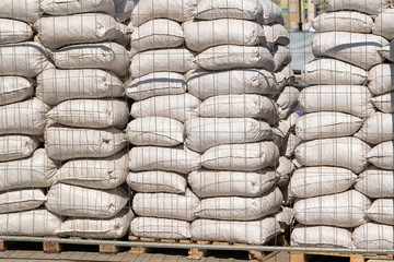 White polyethylene bags with factory products in warehouse.