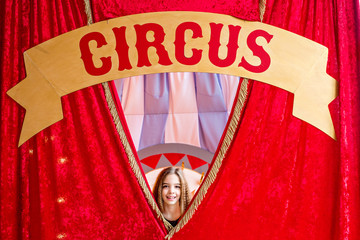 little beautiful girl backstage at the circus waiting for her performance. Duvika posing against the backdrop of circus decorations.