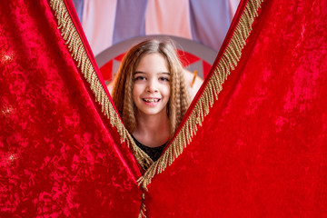 little beautiful girl backstage at the circus waiting for her performance. Duvika posing against...