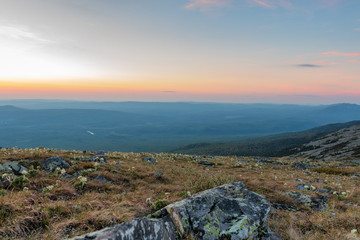 the rock against the blue sky in the rays of dawn