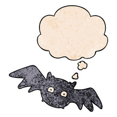 cartoon halloween bat and thought bubble in grunge texture pattern style