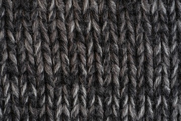 Texture knitted fabric. Warm sweater made of different color yarn. Creative vintage background.