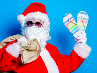 Funny Santa Claus have a fun with vacation flip flops