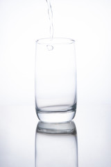 The glass beaker is filled with clear transparent mineral water.