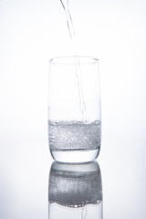 The glass beaker is filled with clear transparent mineral water.