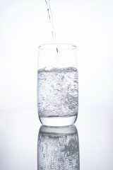 The glass beaker is filled with clear transparent mineral water.