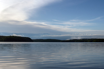 Fototapeta premium After heavy rains, steam rises in the far background over the lake in Oklahoma on a spring morning.
