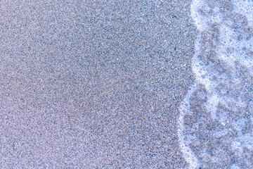 Sand on the sea beach and waves of sea water. Creative vintage background.