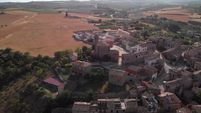 Aerial view of Torres del Rio, Spanish town along Camino de Santiago or Way of Saint James. Urban landscape with buildings and old church in Navarre region, Spain seen from drone flying in sky