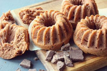 Sweet homemade cupcakes with chocolate on a wooden Board, rustic style. Copy space. Fragrant home-made cakes, recipe.