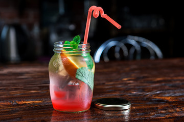 Banks with cold lemonade on wooden background