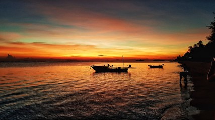 scenic view of  small boats during sunset