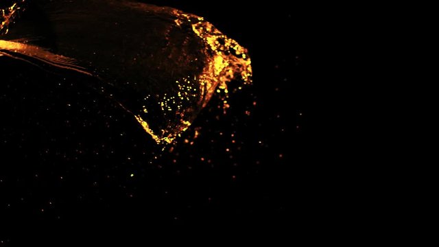 Super Slow Motion Shot of Golden Splash Against Black at 1000fps.