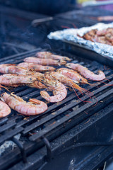 Shrimps on open grill with smoke
