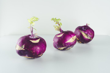 Fresh kohlrabi on white background. Group of raw organic purple turnip cabbage ready to eat.