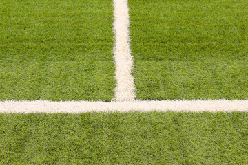 Artificial grass on the football field. Close-up. Background. Texture.