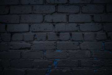 Black brick wall. painted black with shades of blue