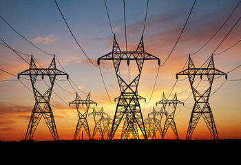 Electricity power pylons over sunset - 276224083