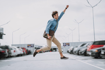 Happy man having fun on the parking lot