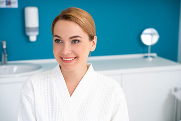 Cheerful lady looking away while being in the medical office